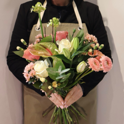 Soft Serenity - This charming arrangement blends creamy white roses, delicate lilies, peach roses and soft blush gerberas with warm, textural accents for a naturally uplifting look. Touches of peach and apricot tones create a gentle, glowing palette that feels fresh, comforting and effortlessly stylish.
